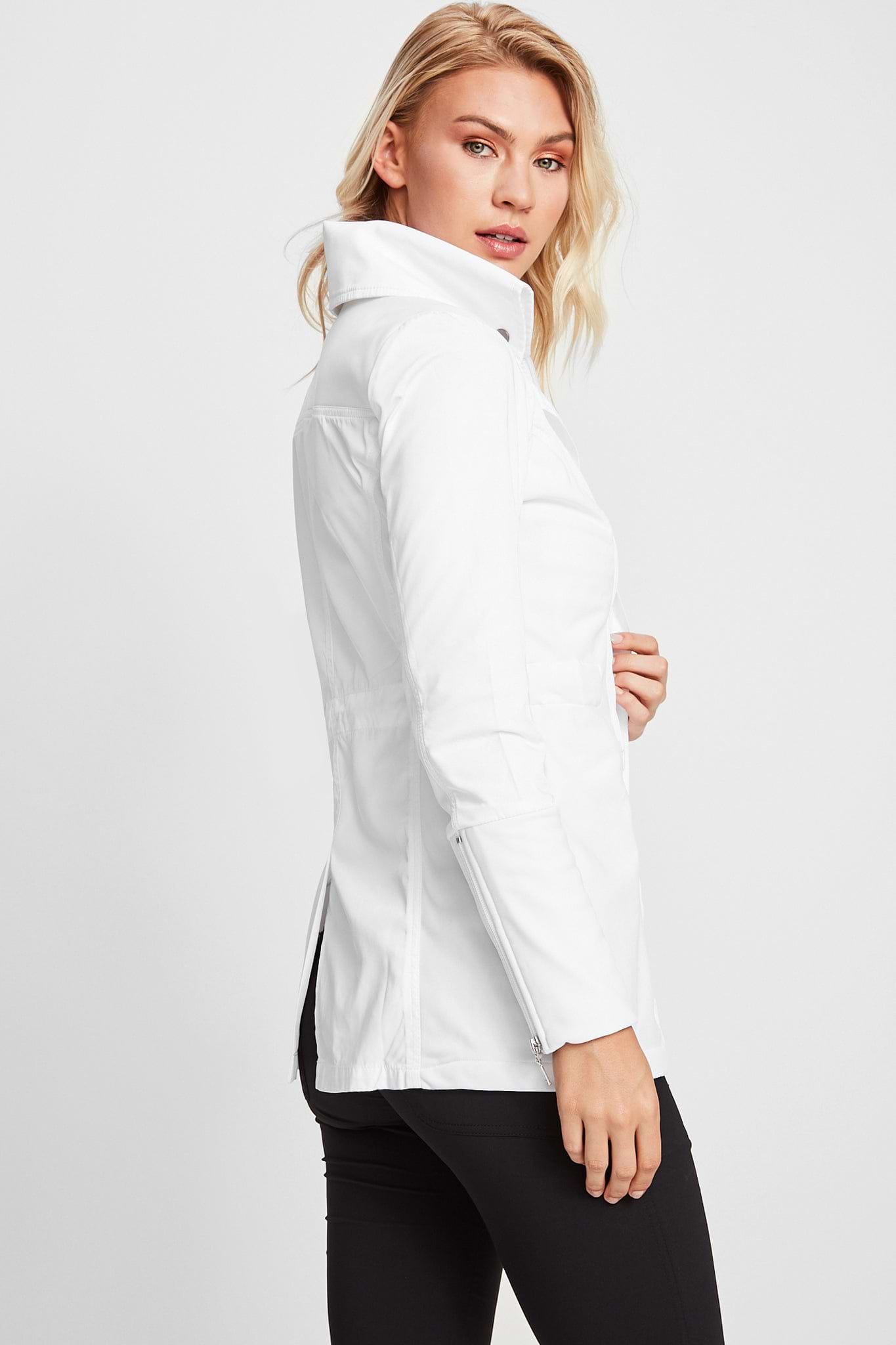 The Best Travel Jacket. Woman Showing the Side Profile of a Travel City Slick Jacket in White