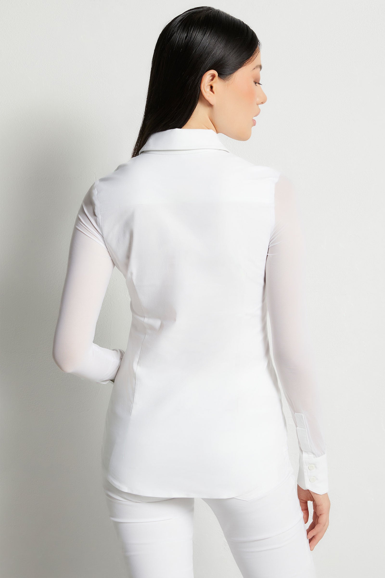 The Best Travel Shirt. Woman Showing the Back Profile of a Beth Button Front Shirt in White