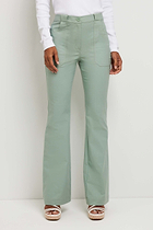 The Best Travel Pant. Woman Showing the Front Profile of a Darby Pant in Sage.