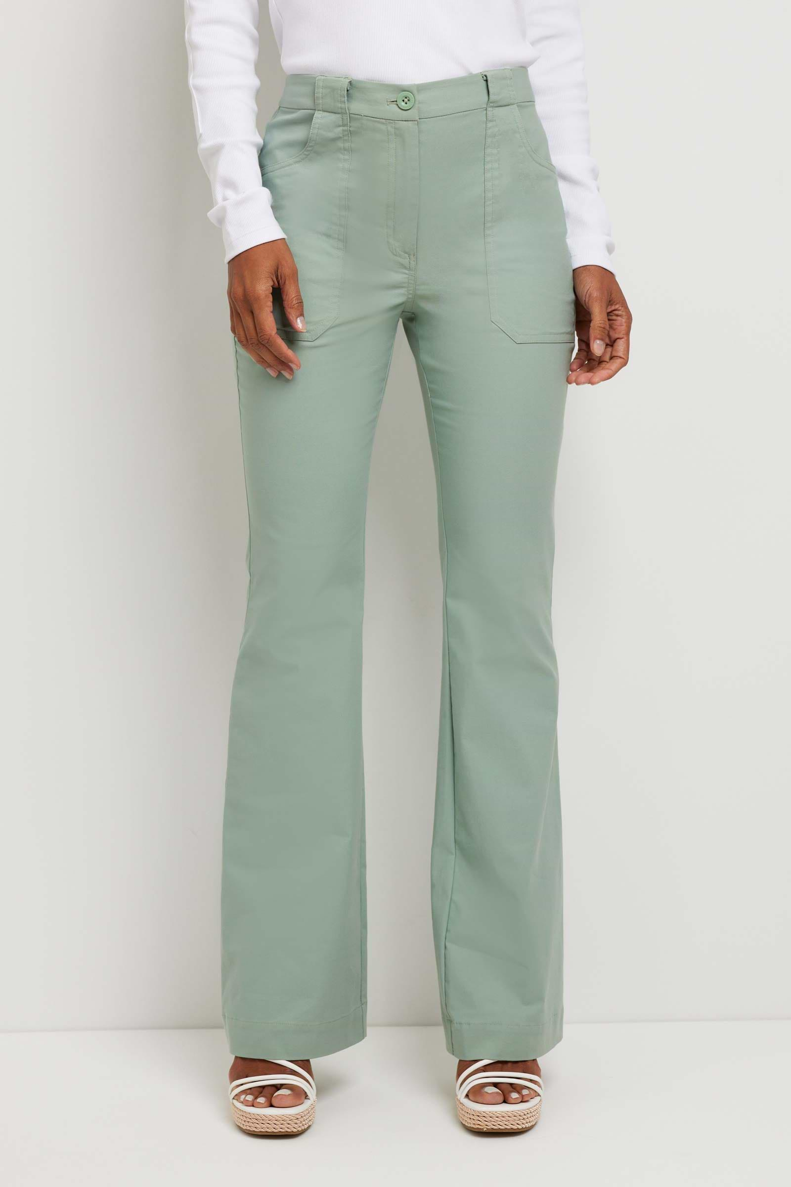 The Best Travel Pant. Woman Showing the Front Profile of a Darby Pant in Sage.