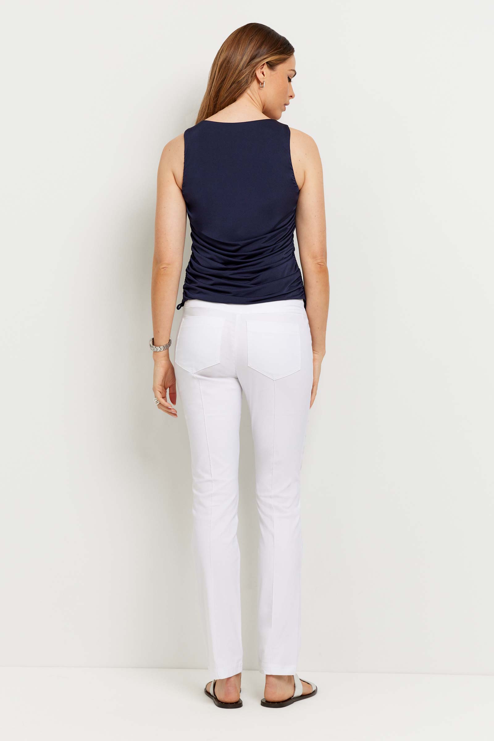 The Best Travel Top. Woman Showing the Back Profile of an Alix Top in Navy.