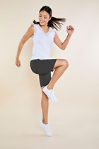 The Best Travel Shorts. Woman Showing the Side Profile of an Apiedi Shorts in Grey.