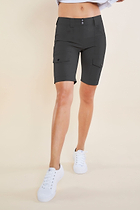 The Best Travel Shorts. Woman Showing the Front Profile of an Apiedi Shorts in Grey.