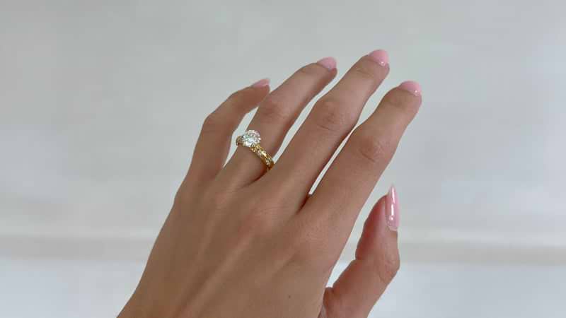 Custom vintage inspired diamond ring on hand.