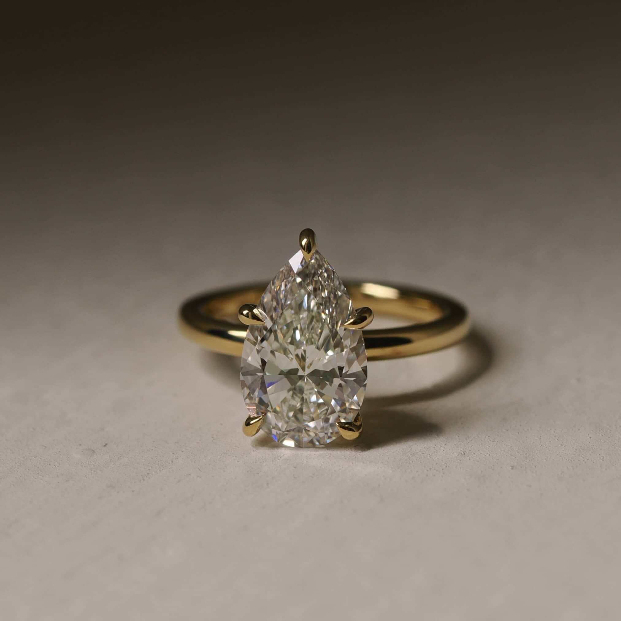 Low Profile White Gold Pear Shaped Engagement Ring Plum