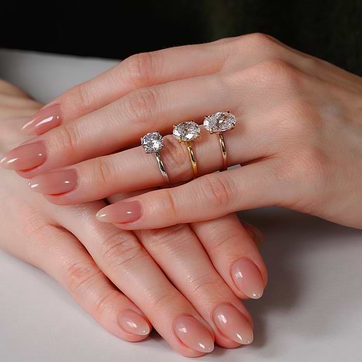 Platinum, yellow gold, and rose gold rings on hands
