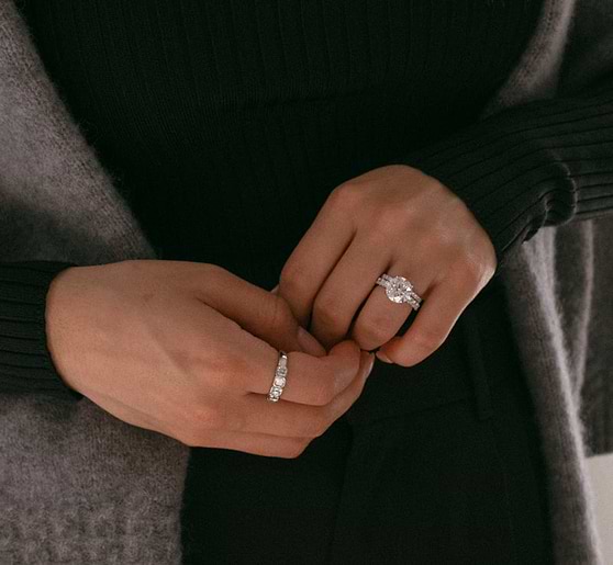 radiant cut diamond wedding and engagement ring on a woman's hand