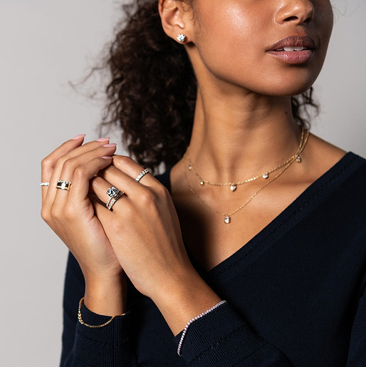 Woman wearing a mixture of white gold and yellow gold jewelry.