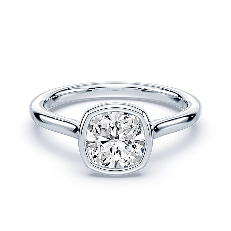 white gold cushion cut diamond engagement ring with bezel setting