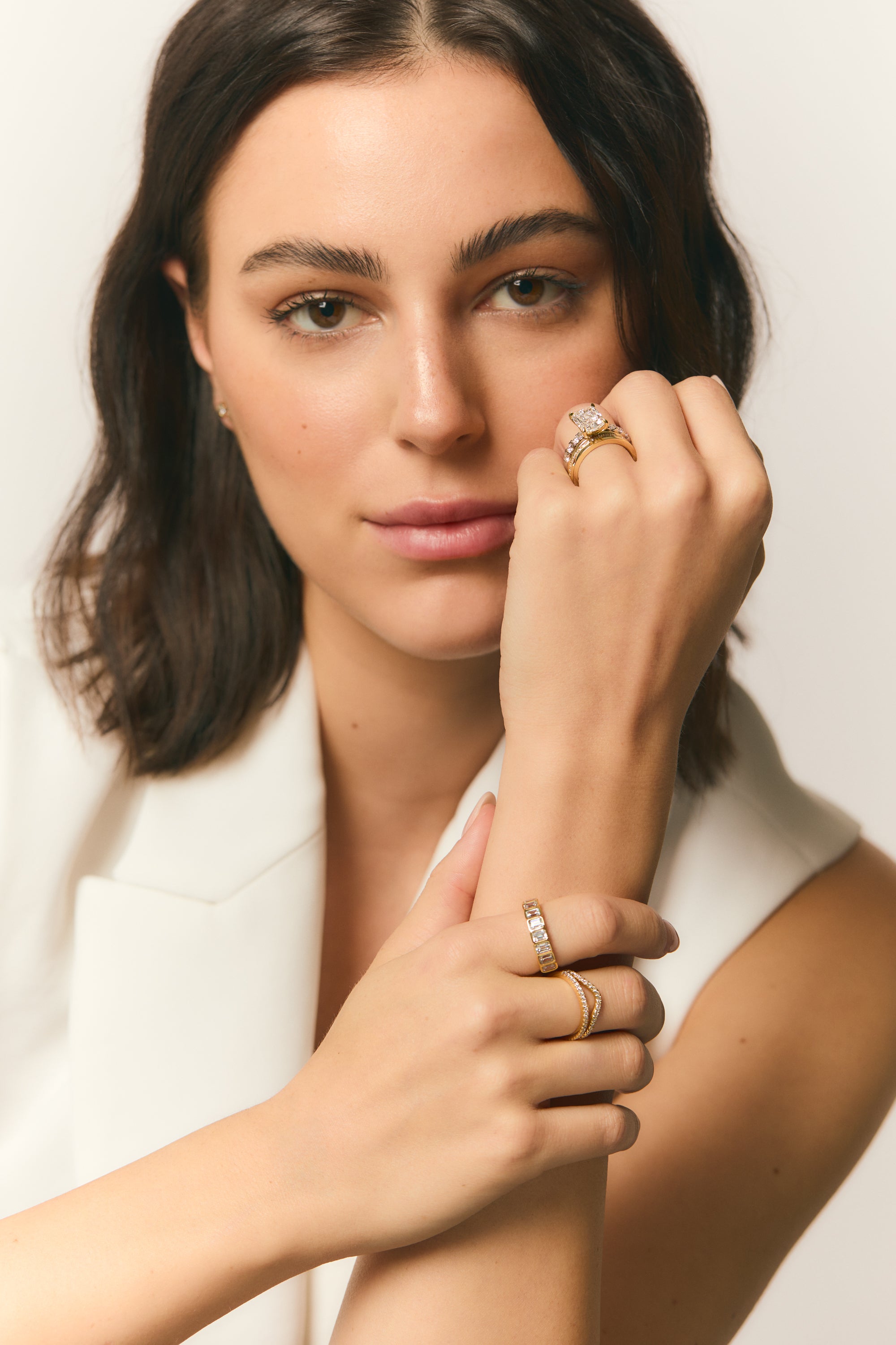 smiling woman with gold and diamond rings and fine jewelry