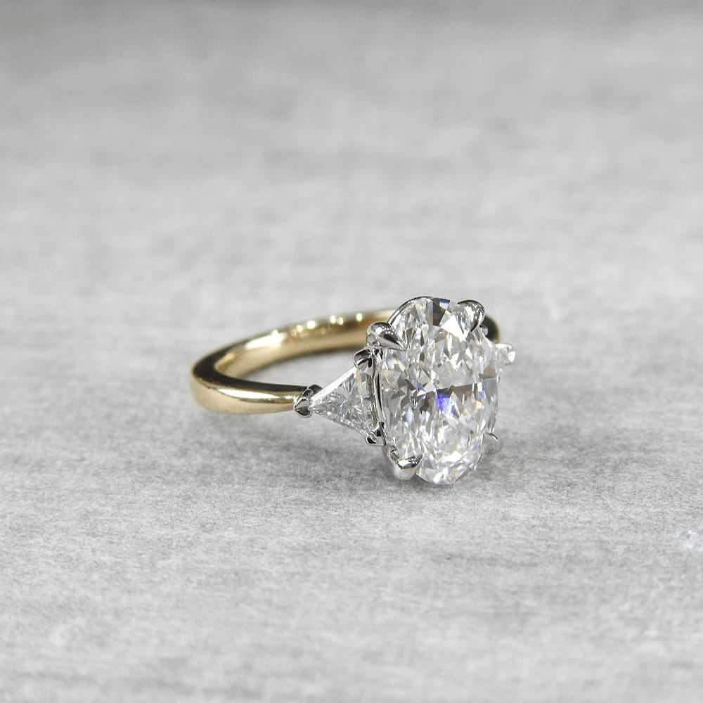 oval diamond ring with trillion side diamonds