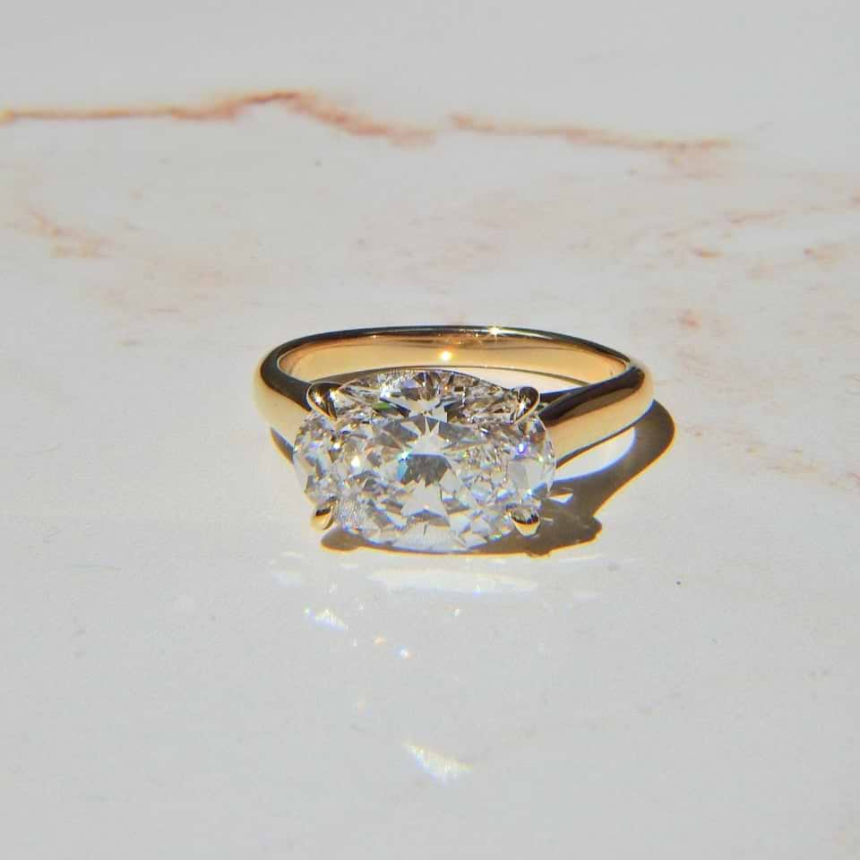 east west yellow gold oval diamond ring