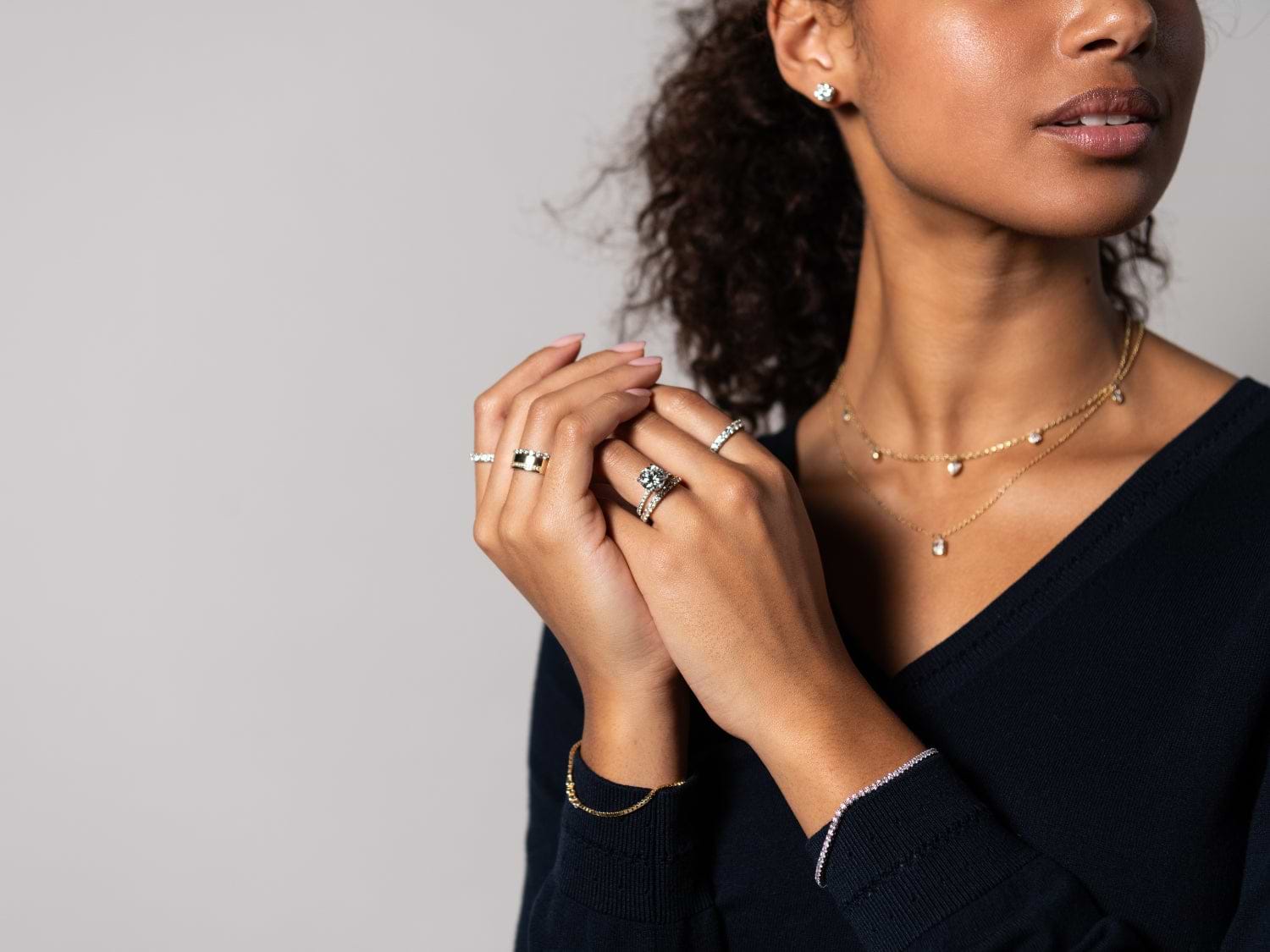 young woman with diamond jewelry jewelry looking to the side