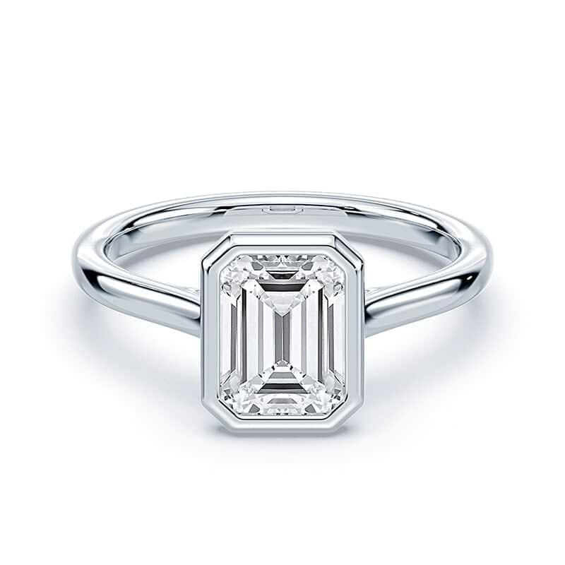 white gold emerald cut diamond engagement ring with bezel setting