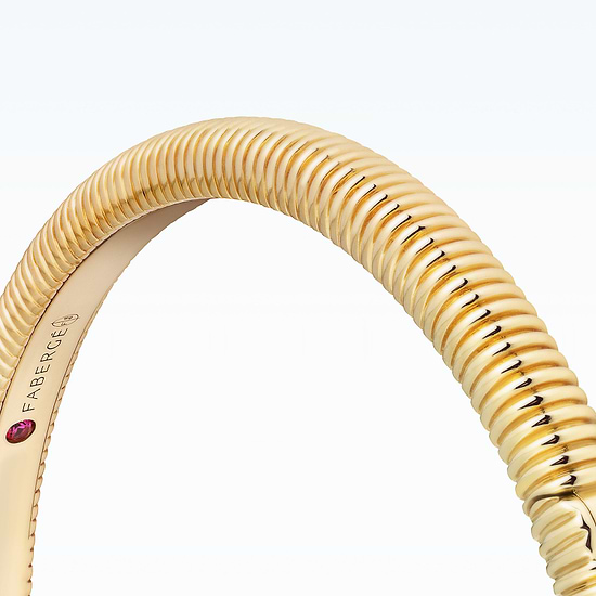 New Discoveries Jewellery Collection - Gold bracelet with a ruby stone on a white background