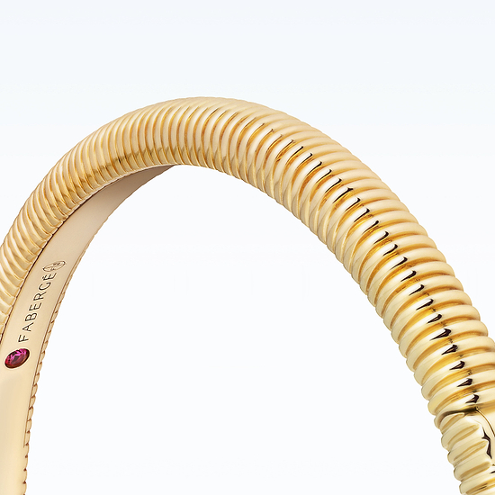 New Discoveries Jewellery Collection - Gold bracelet with a ruby stone on a white background