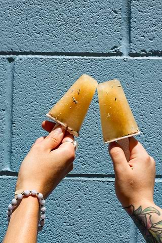 Hands holding Lavender Lemonade Herbal Popsicles