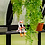 Two cartoon duck figurines sitting on a ledge with greenery in the background