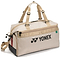 The Yonex BA72611EX Gearlogic Badminton Boston Bag in beige is made from recycled polyester, with tan handles, a front zip pocket, black base, red and black side accents, and the Yonex logo printed in black on the side.