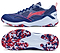 The Li-Ning Blast JF-01 Lite Unisex Badminton Shoes in blue and red feature the Li-Ning brand, white and red accents, and a high-traction blue/red camo outsole visible from the bottom view.