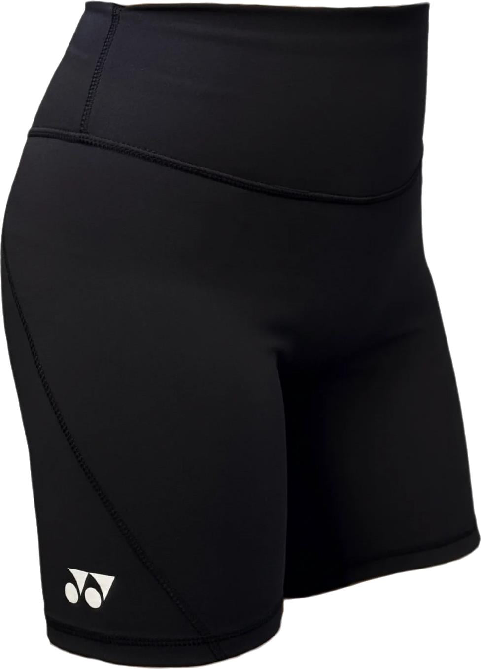 The Yonex YTS2024 Womens Core Badminton Shorts in black feature a small white logo, high-waisted moisture-wicking fabric, and smooth, stretchy material—ideal for sports or workouts. Shown worn in the image. Brand: Yonex.