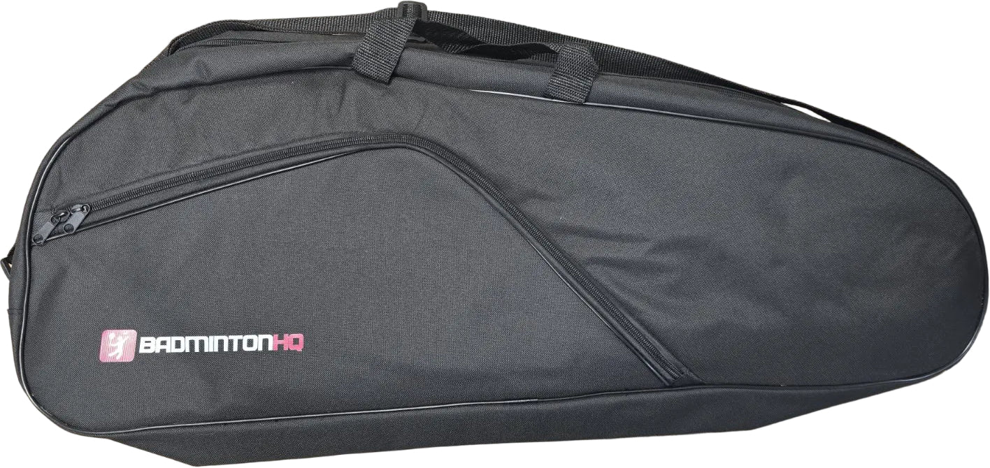 The BadmintonHQ 6 Racket Badminton Bag - Black features a zippered side pocket, handle, and white/pink "BADMINTON HQ" logo—ideal for carrying your rackets in style.