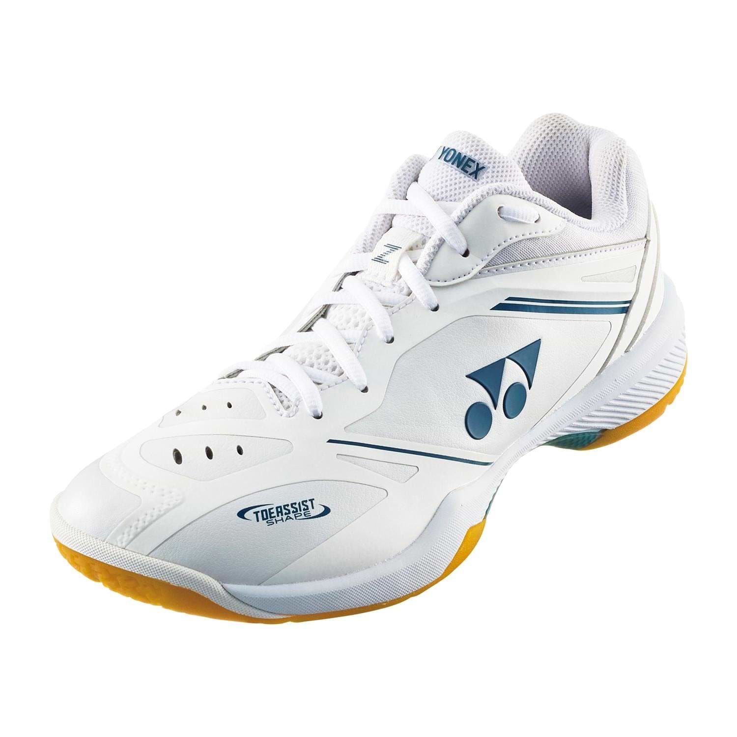 The Yonex Power Cushion 65Z4 Men's Badminton Shoes in white feature blue accents, a lace-up front, and yellow soles—ideal for advanced indoor players.