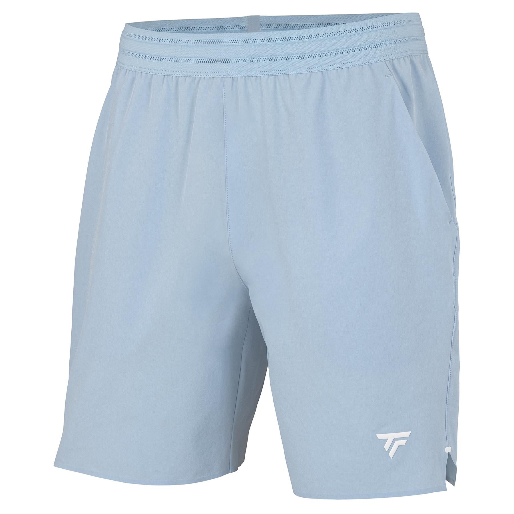 Tecnifibre Team Stretch Men’s Badminton Shorts in Glacier Blue feature an elastic waistband, side pockets, and a small white logo on the lower left leg. These Tecnifibre shorts are shown against a plain white background.