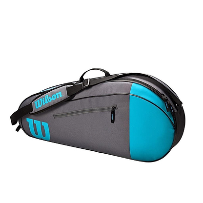 The Wilson Team Collection 3 Racket Bag in blue and grey flaunts a stylish color scheme, equipped with a shoulder strap, handle, and zippers. Ideal for transporting your tennis essentials, it prominently showcases the Wilson logo.