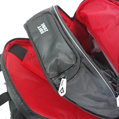 Open the Karakal Pro Tour 30 2.1 Badminton Backpack in black and white, featuring multiple compartments. The lining is bright red and includes a section labeled "SOFT ZONE." Enjoy comfort with its padded shoulder straps, and notice the branded zipper pull.