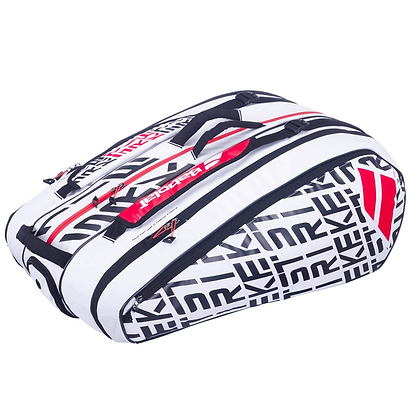 The Babolat RH12 Pure Strike 12 Racket Bag in white, black, and red features bold black lettering with red accents. It includes multiple zippered compartments, a clear view shoe compartment, and a convenient top handle for easy carrying.