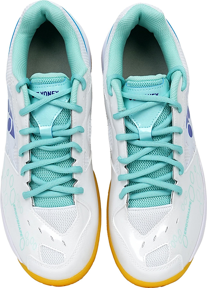 Top view of Yonex Power Cushion SHB 101 Badminton Shoes by Yonex in white and mint, featuring mesh panels, teal laces/interiors, yellow soles, and blue logos—designed to deliver superior shock absorption on the court.