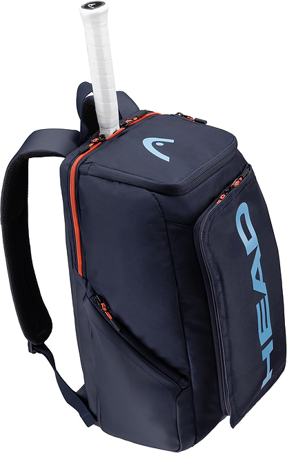 The HEAD Pro 28L Badminton Backpack in navy features orange zippers, a padded shoulder strap, a dedicated racket compartment with the handle protruding from the top, and a large blue HEAD logo on the front pocket.