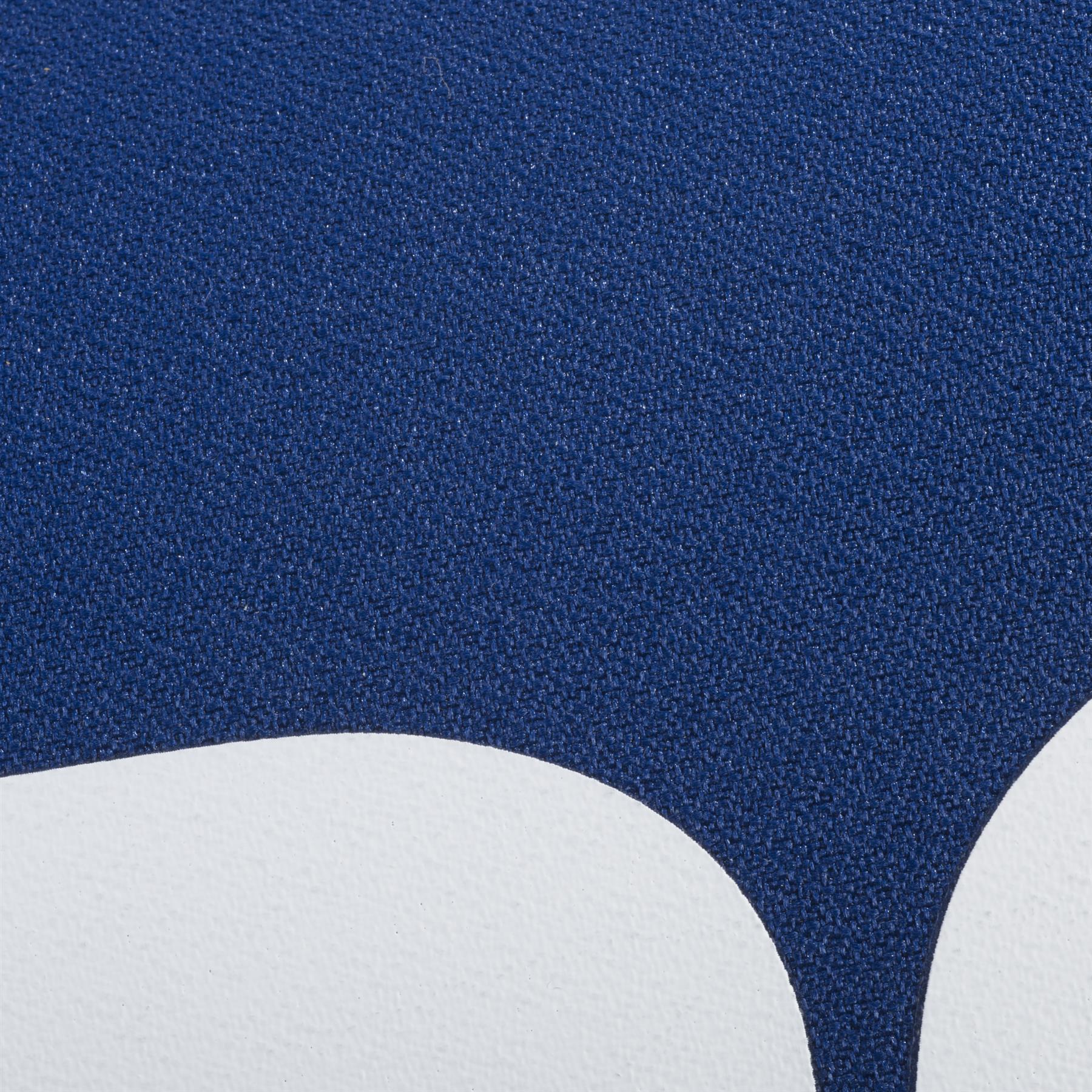 Close-up of a textured surface with a dark blue area above two curved white shapes, echoing the minimalist style of the Babolat Court XS 3 Racket Badminton Bag - Blue by Babolat.