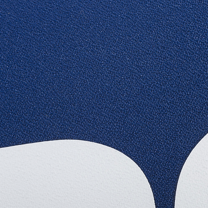 Close-up of a textured surface with a dark blue area above two curved white shapes, echoing the minimalist style of the Babolat Court XS 3 Racket Badminton Bag - Blue by Babolat.