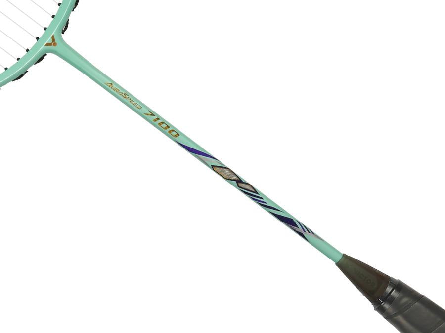 Close-up of the Victor Auraspeed 7100 4U Badminton Racket by Victor in teal, featuring geometric black, purple, and gold patterns on the shaft and a black grip—perfect for beginners.
