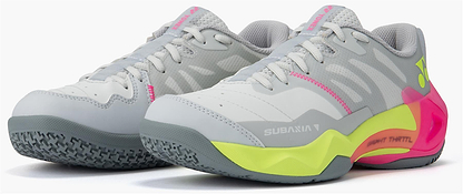 The Yonex Subaxia GT Women's Badminton Shoes in light grey feature gray laces, neon yellow and bright pink accents, textured gray soles, Power Cushion Rev comfort, and a white "SUBANIA" logo on the side.