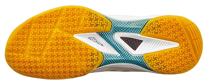 The image shows the sole of Yonex Power Cushion 65Z4 Men's Badminton Shoes in white, with a yellow textured grip, teal midfoot accents, white geometric details, and the Yonex logo at the center—ideal for advanced players.