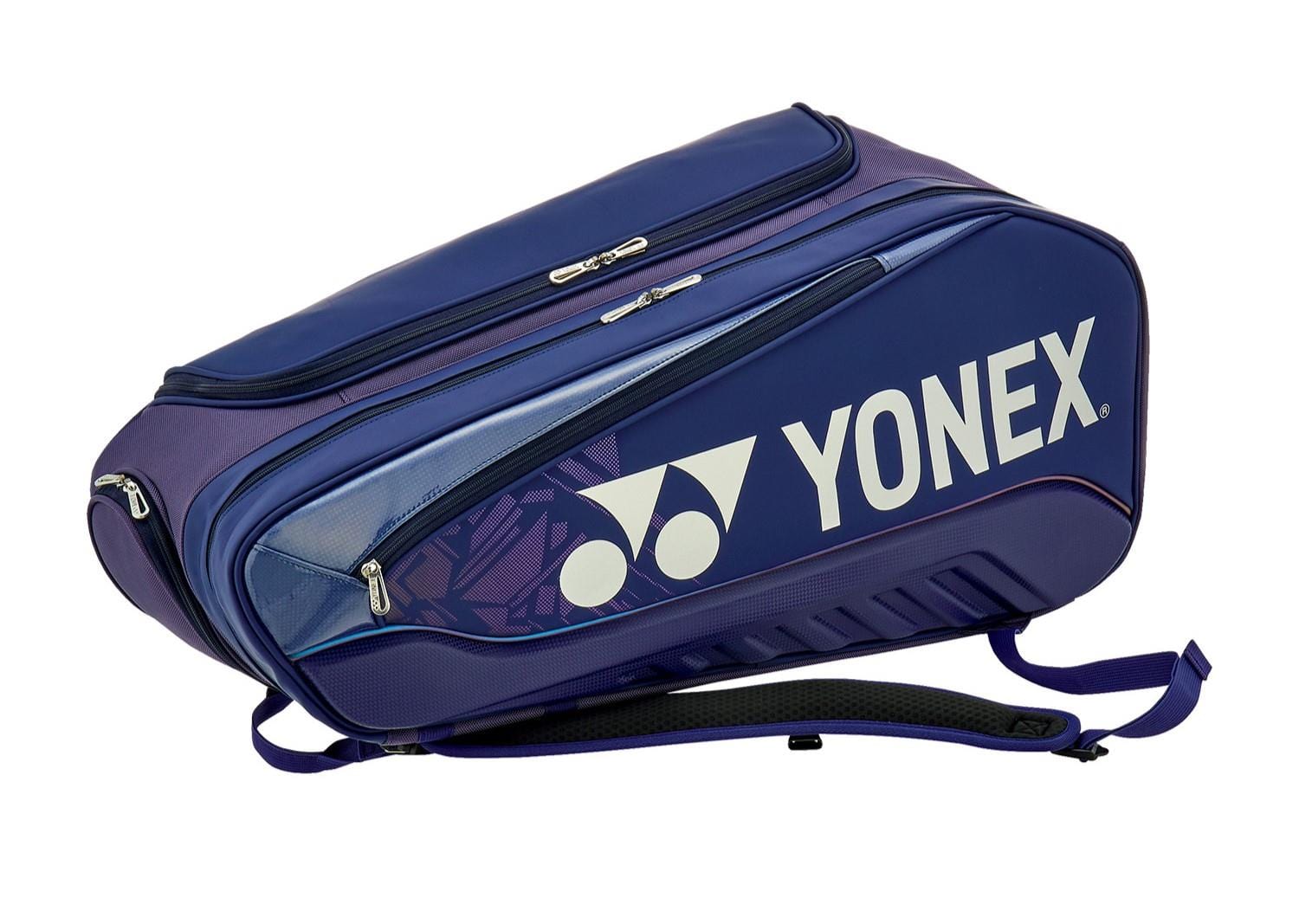 The Yonex 02526EX Expert 6 Racket Badminton Bag in Navy Blue has multiple zippered compartments, a dedicated racket divider, adjustable shoulder straps for comfort, and a detachable laundry pouch for convenience.