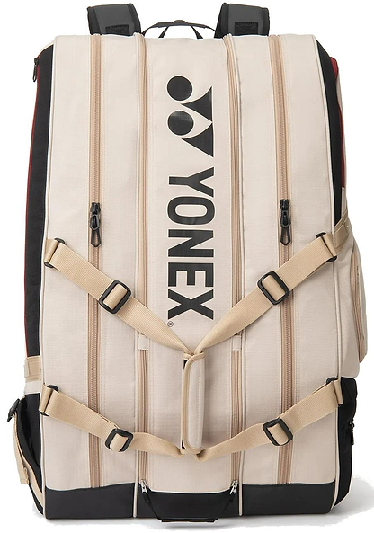 The Yonex BA726212EX Gearlogic 12 Racket Badminton Bag in beige features a black logo, four vertical zippered compartments, black accents, and adjustable beige straps—perfect for stylishly carrying your badminton gear.