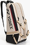 The Yonex BA72626EX Gearlogic 6 Racket Badminton Bag in beige features black and red accents, multiple zippered compartments, adjustable straps, recycled polyester material, and a Yonex logo on the side.