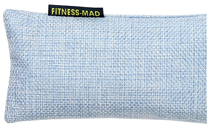 A light blue woven eye pillow showcasing the "Fitness Mad" label in yellow text. The pillow is crafted with a textured, crosshatch fabric infused with active charcoal, serving as the Fitness Mad Sports Odour Absorber to maintain its freshness and appeal.
