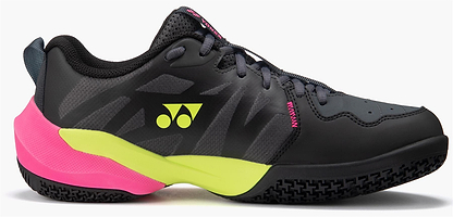The Yonex Subaxia GT Men's Badminton Shoes in dark grey feature neon yellow and pink accents, a geometric pattern, lace-up closure, GRPHT THRTTL technology, and a textured rubber sole.