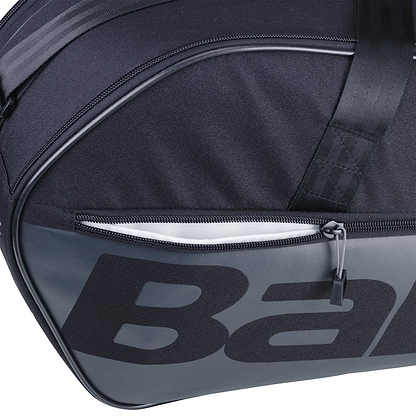 Close-up of the Babolat Court M 6 Racket Badminton Bag in black, showcasing a zippered pocket and bold lettering. Made from recycled PET, the durable fabric and prominent zip pull emphasize its sleek design.