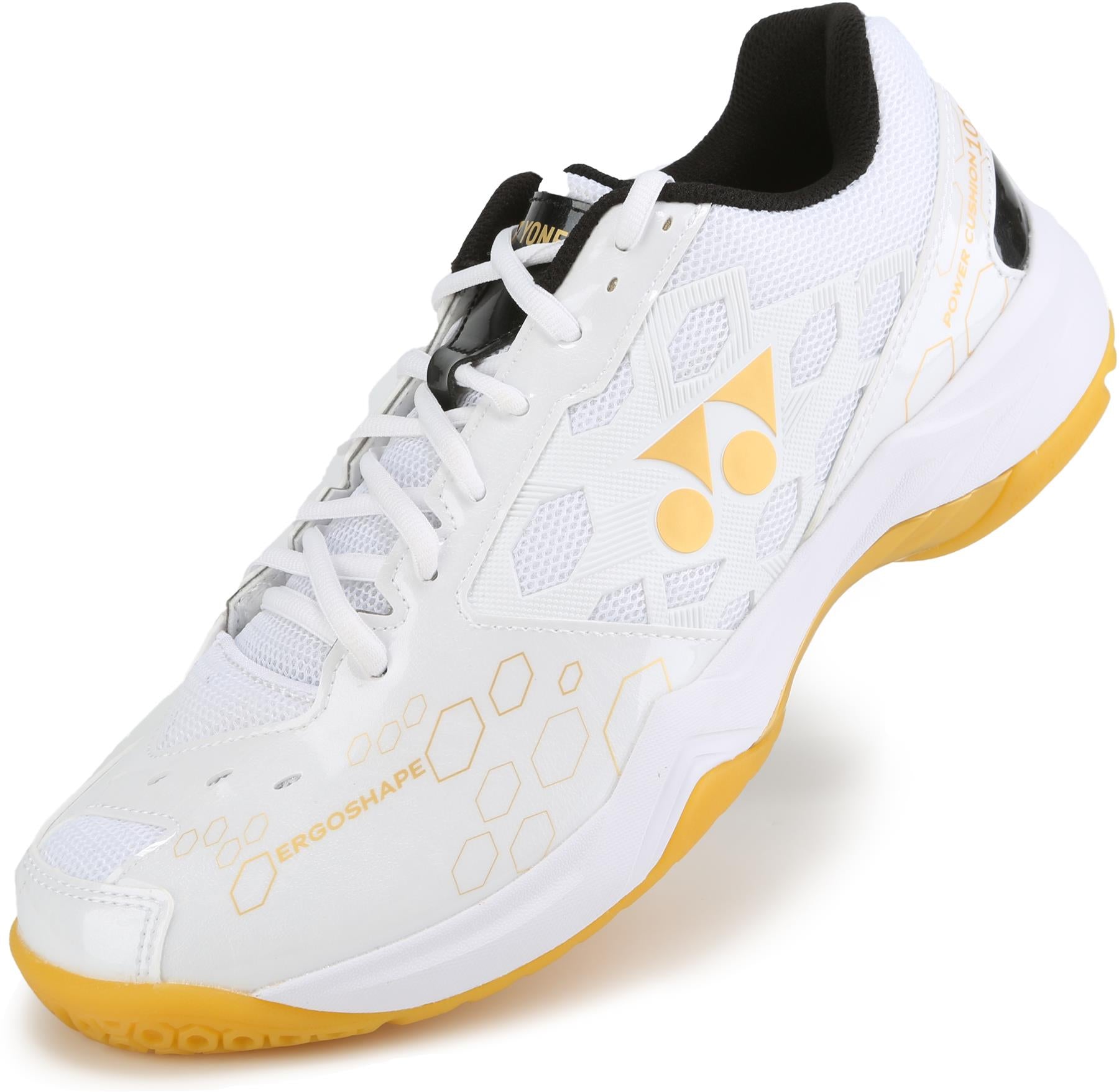The Yonex Power Cushion SHB 101 Badminton Shoes in White/Gold feature a geometric design, yellow-accented sole for shock absorption, black inner lining, and the Yonex logo—perfect for court performance.