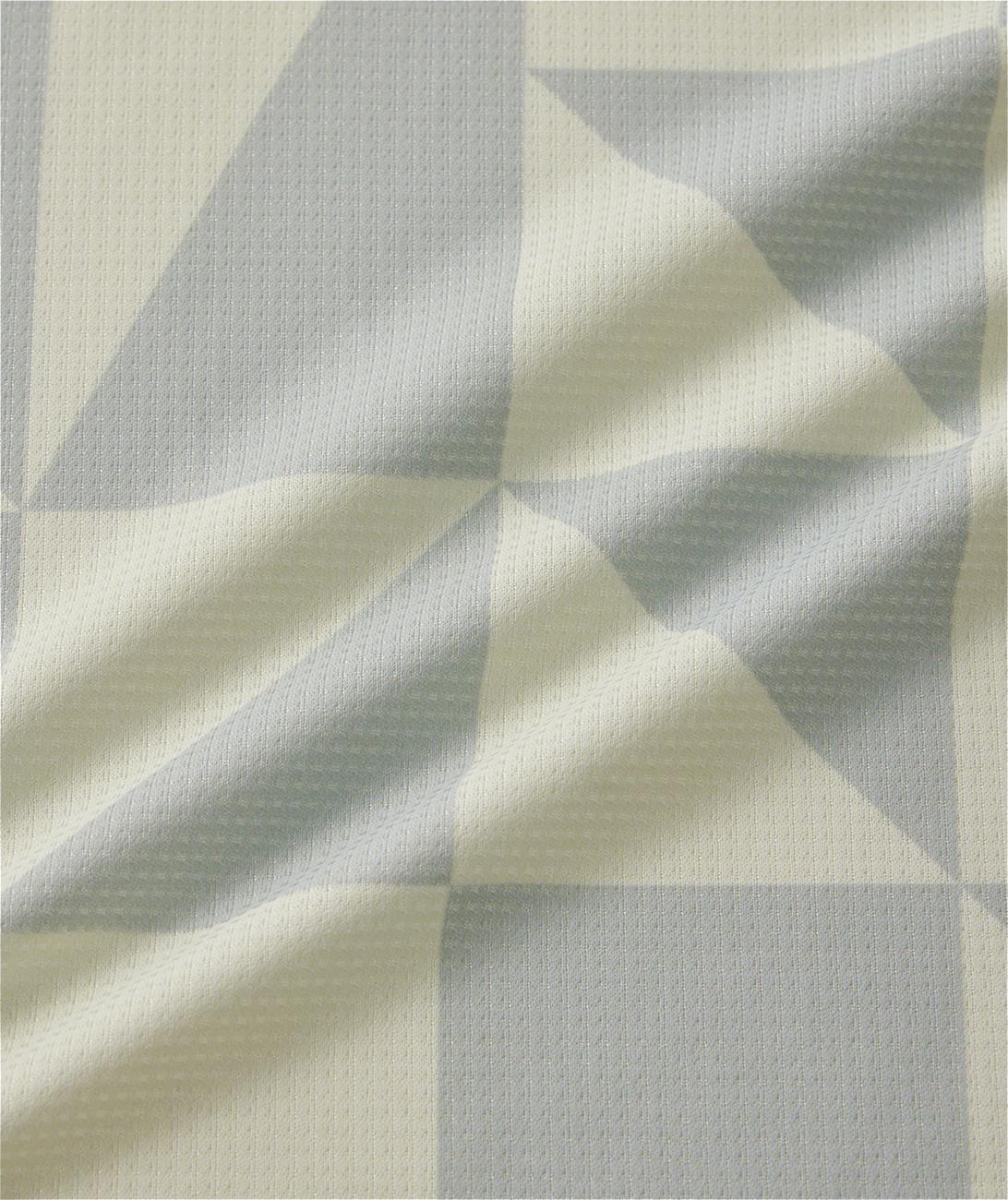 A close-up of the Yonex 10712YX Crew Neck Men's Badminton T-Shirt in champagne shows its light fabric with subtle geometric texture—perfect for quick-drying sportswear.