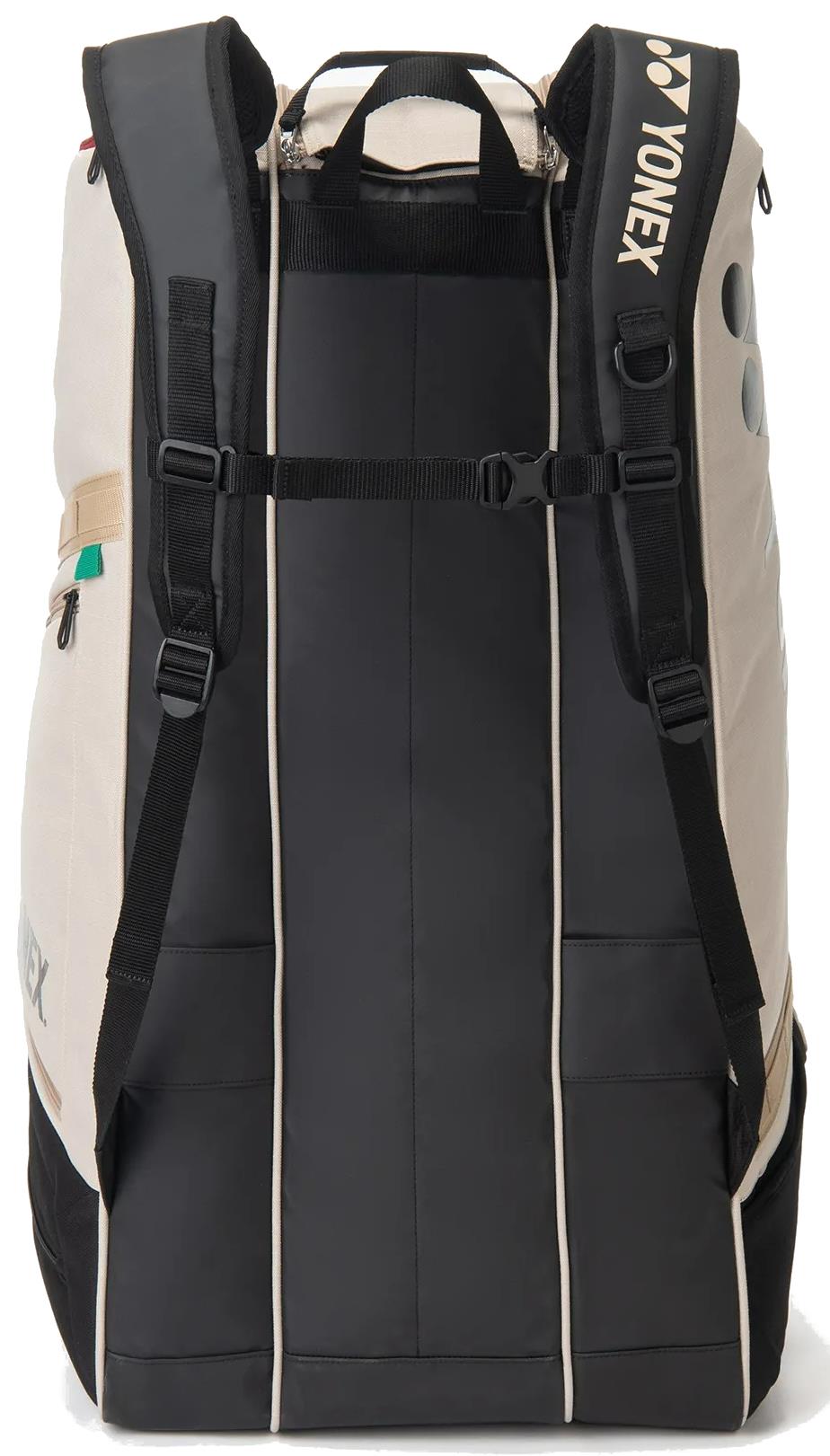 The Yonex BA72629EX Gearlogic 9 Racket Badminton Bag in beige features padded shoulder straps, a top handle, side pockets, and a rectangular shape for your gear. The Yonex logo appears on one strap.
