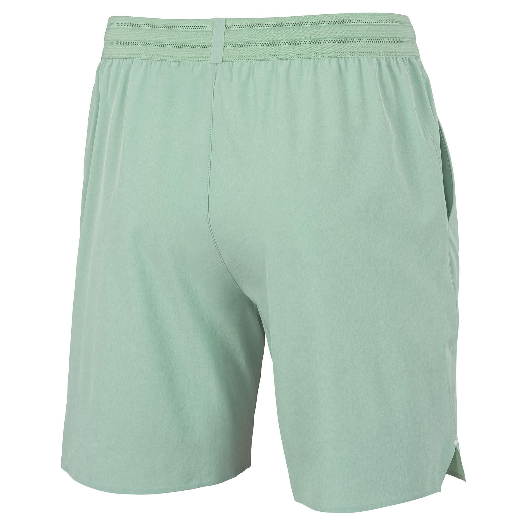 Tecnifibre Team Stretch Men's Badminton Shorts in sage green, shown from the back with an elastic waistband and side pockets, displayed against a plain white background.