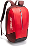 The Yonex 42512EX Team Badminton Backpack in Ruby Red features a front zipper pocket, blue zipper detail, adjustable shoulder straps, and a vertical Yonex logo on the side.