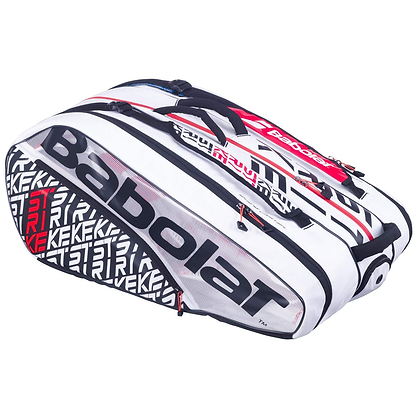 The Babolat RH12 Pure Strike 12 Racket Bag in white with black and red accents offers a spacious design with multiple compartments, including a durable insulated section and a transparent shoe compartment. It features prominent branding and a textured graphic design.